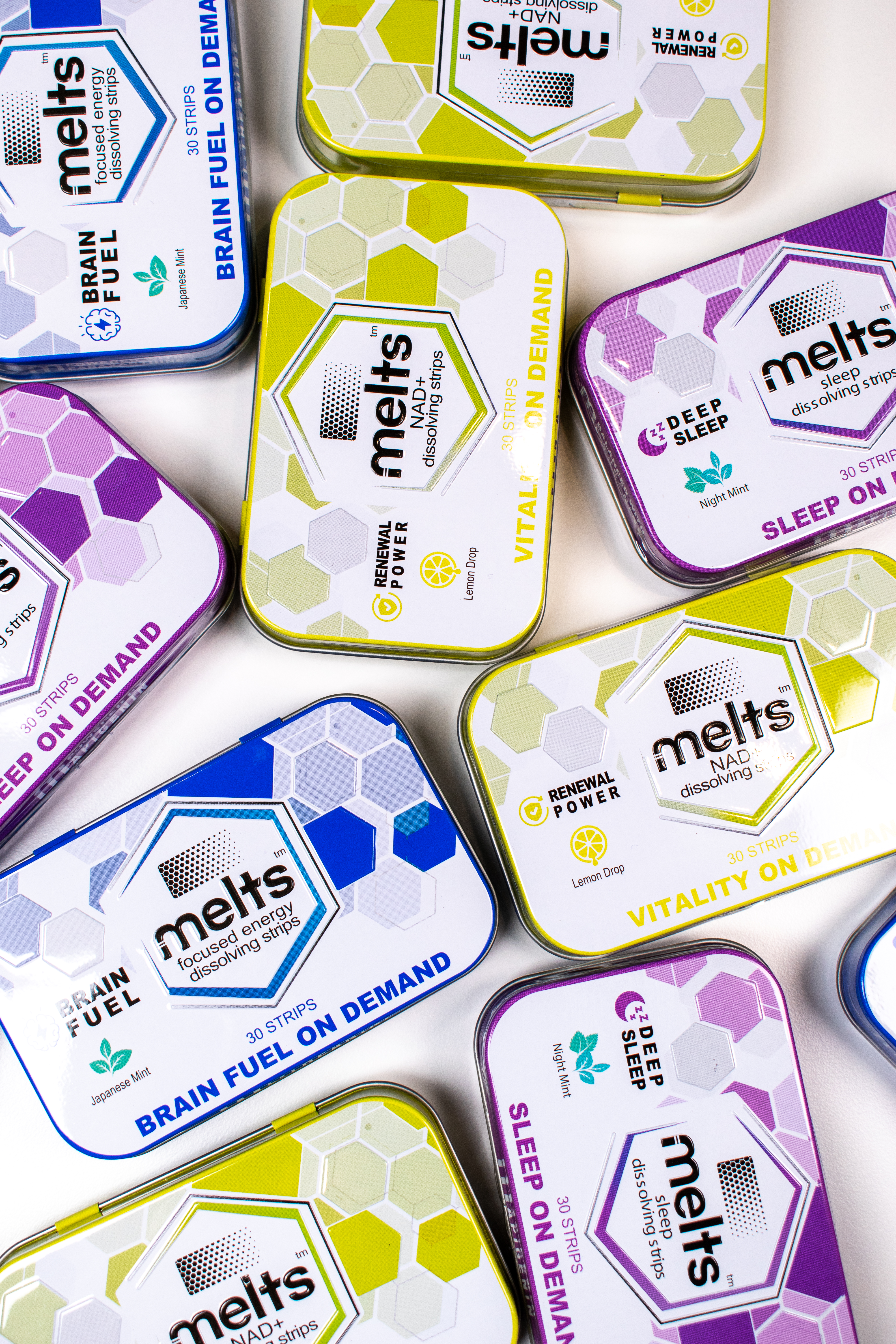 An assortment of Melts Brain Fuel, NAD+, and Deep Sleep tins